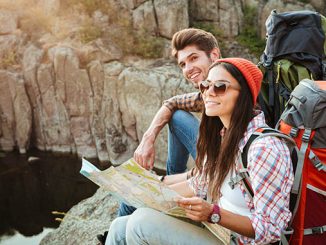 Traveler couple with map near the canyon