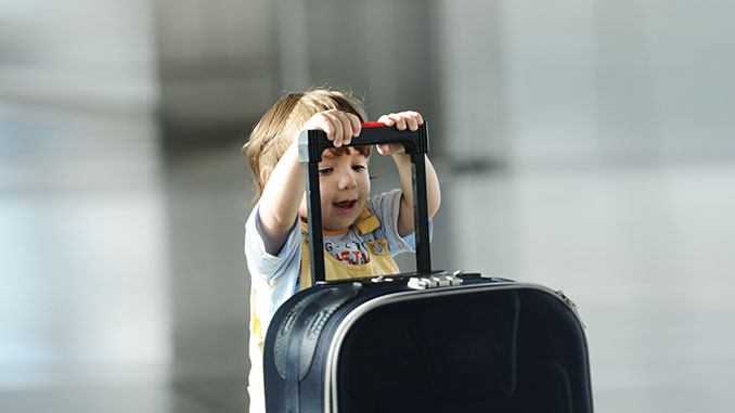 Little cute baby with bag on airport traveling
