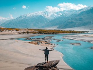 man alone looking at mountains