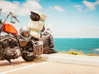 man and motorcycle seaside view