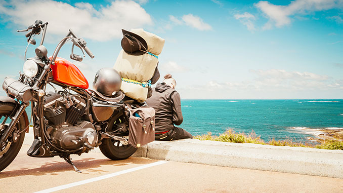 man and motorcycle seaside view