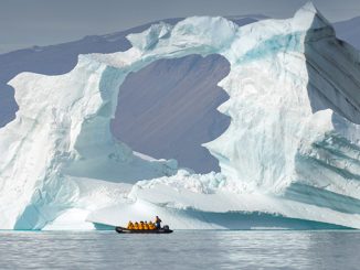 tourists near iceberg