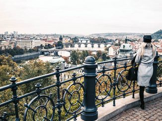 woman looking over the autumn prague