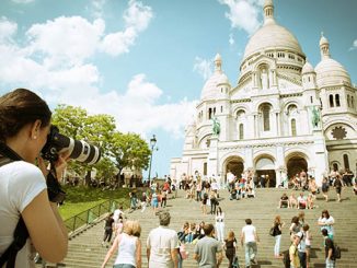 woman traveler photographing a church