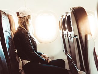 young woman traveling by airplane